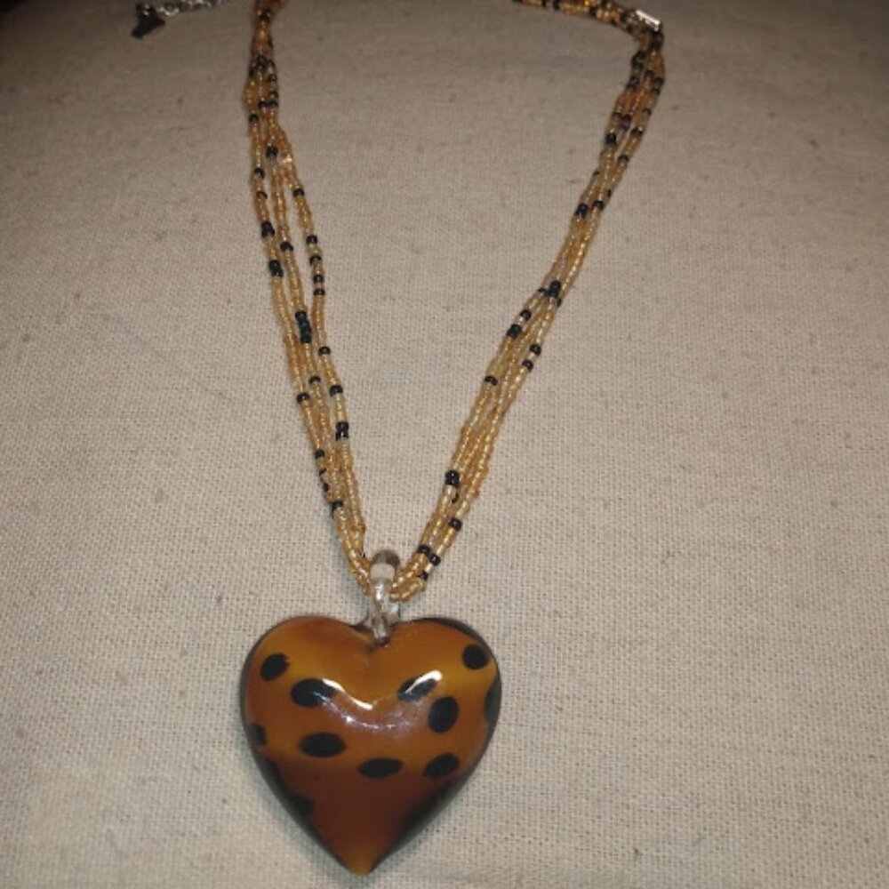 World end imports: Art glass heart shaped leopard spot design pendant necklace.